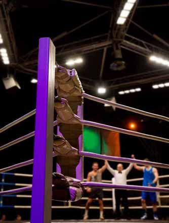 A boxing ring with a referee holding up boxers' hands